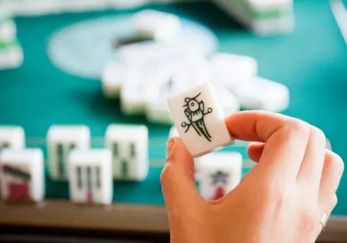 Riichi mahjong in focus amidst other mahjong tiles