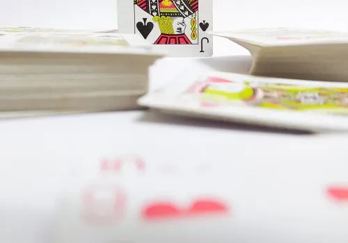 Some playing cards scattered on a white table