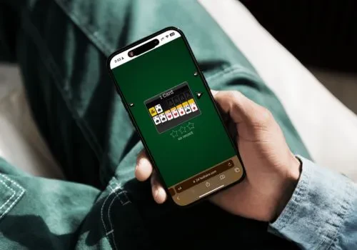 A game of solitaire played on the 247 Solitaire website shown on a phone screen
